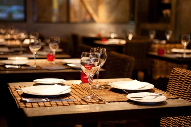 Image of fine dining setup in a restaurant; learn more about the best restaurant stocks to buy now