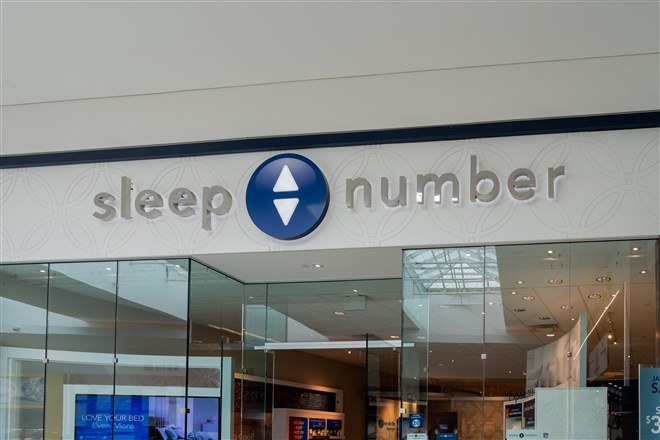 photograph of storefront with sleep number name and logo