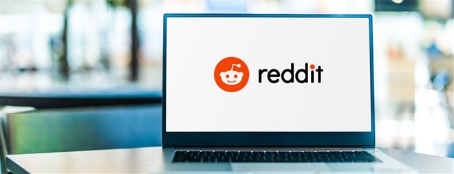 photo of laptop computer with reddit logo on screeen