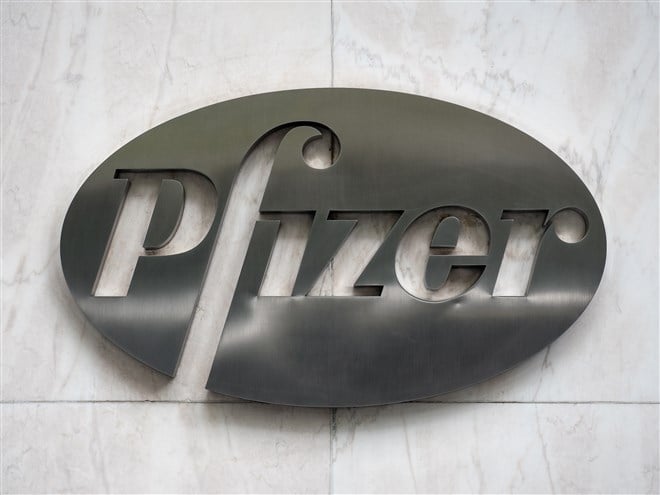 metallic pfizer logo mounted on wall 