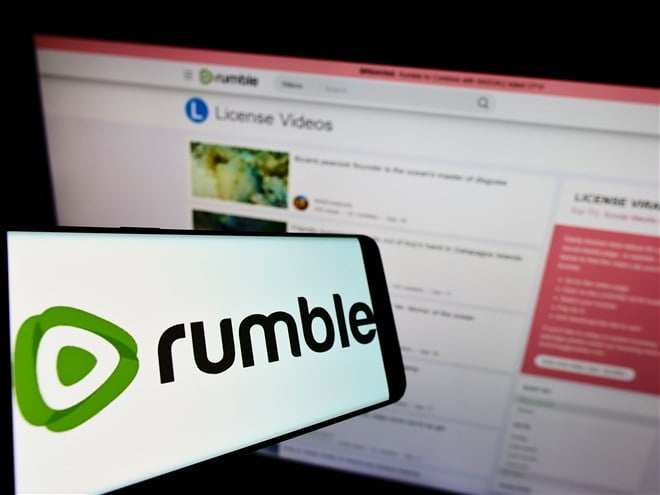 photo of mobile device with rumble logo on screen in front of laptop