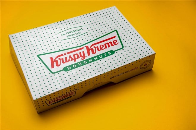 photo of a box of Krispy Kreme Donuts on a yellow background