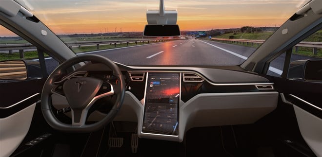 Photo of the view from inside a Tesla X electric car on the highway. Tesla's Q1 2024 earnings report highlights challenges and opportunities on the road ahead