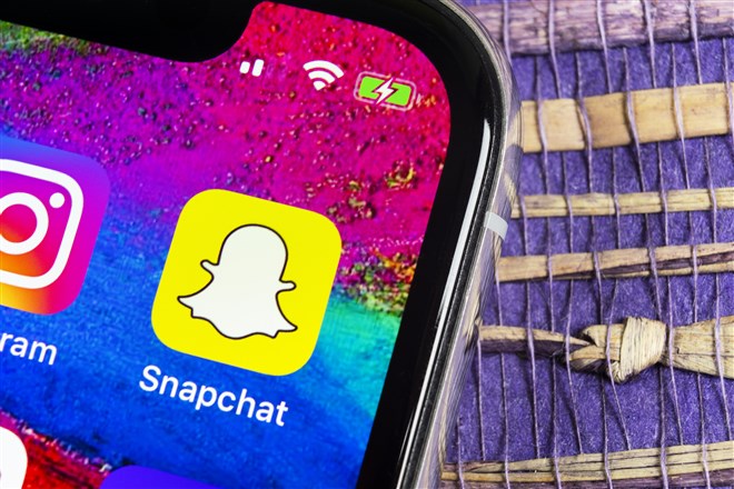 Photo of smartphone display snapchat app on its screen