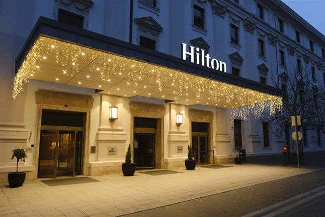 Photo of the exterior of a Hilton Hotel. Hilton Worldwide's asset-light strategy proves beneficial for investors as they deliver a solid earnings report.