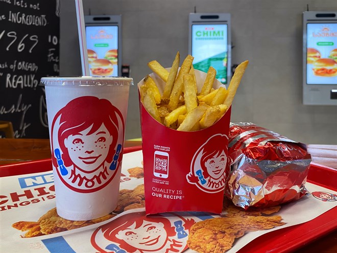 Close-up of Wendy's french fries, drink and burger on a tray. Wendy's recently released Q1 2024 earnings that showed growth amid economic headwinds.