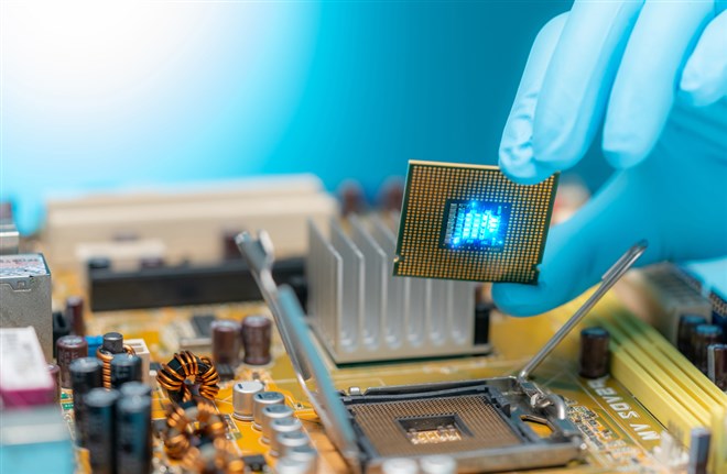 Electronic engineer hand putting computer chip on socket. Chipset on electronic circuit board of PC mother board. CPU chip. Electronic components. Computer hardware. Upgrade computer processor chip.