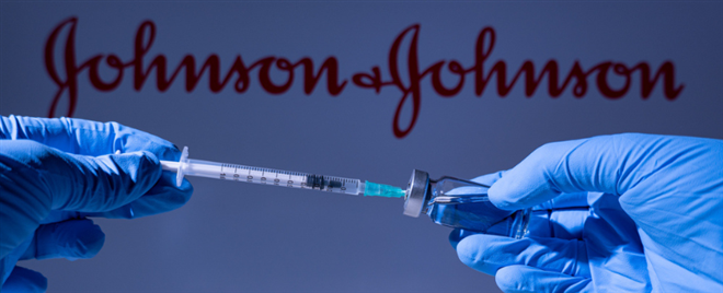 Photo of two medical gloved hands filling a syringe