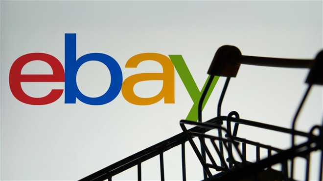 A silhouette of a shopping cart is in front of the Ebay.com