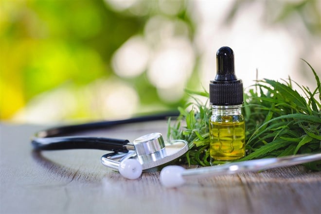 CBD oil cannabis extract, Hemp oil bottles and hemp flowers on a wooden table, Medical cannabis concept — Photo