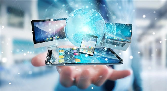 Businessman connecting tech devices and icons applications