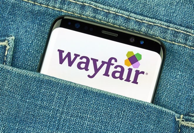 Wayfair logo on a smart phone, tucked in a jeans pocket