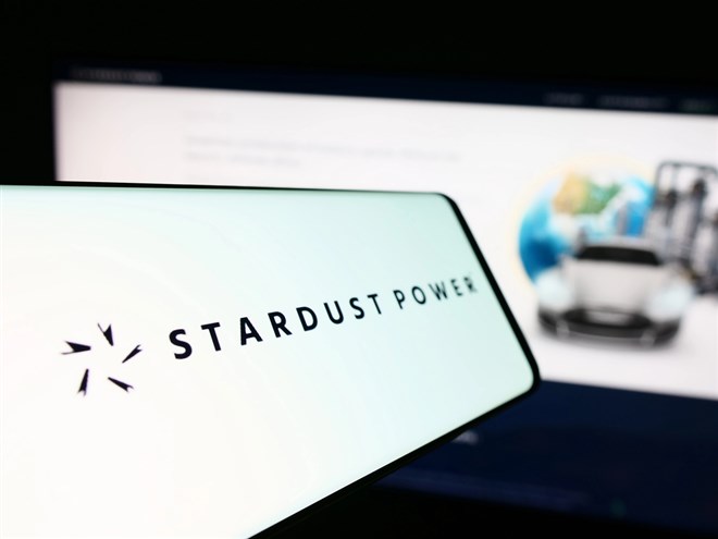 mobile phone with logo of american lithium refining company stardust power inc. in front of website. focus on center-left of phone display.