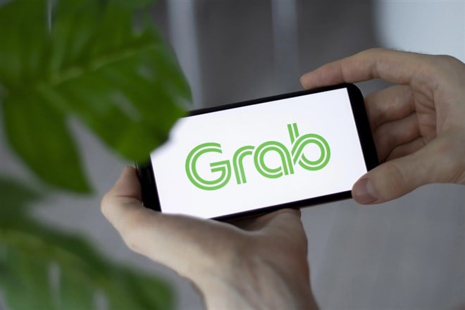  closeup of smartphone screen grab logo lettering with in mans hands