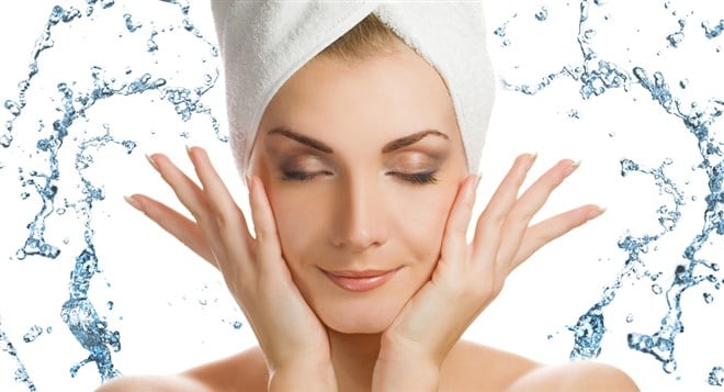 woman cleansing face 