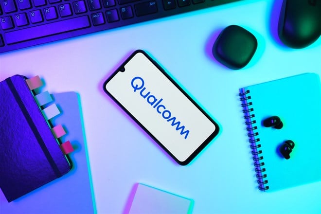 Qualcomm logo open on a smartphone on a desk.
