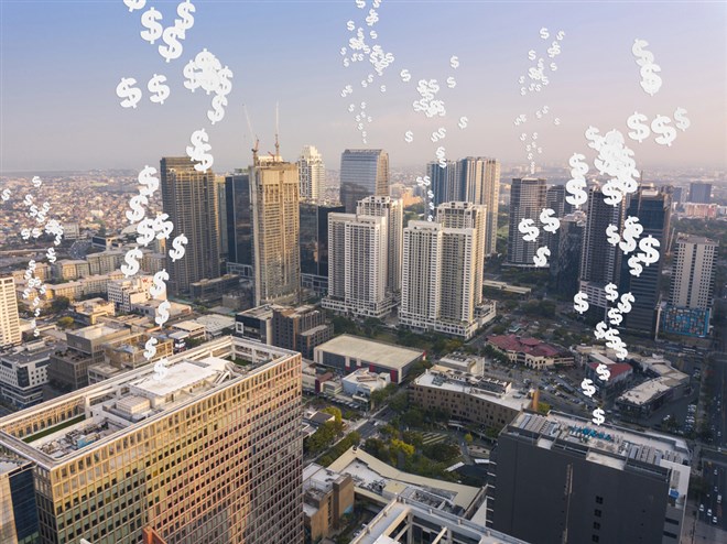Dollar signs rising from a city skyline representing passive income from real estate investment. 