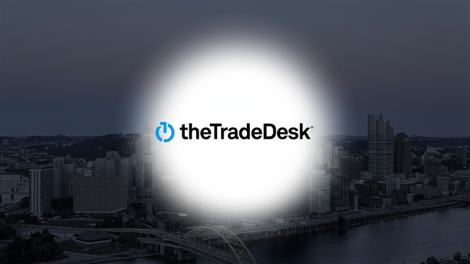 The Trade Desk logo featured in front of city skyline.
