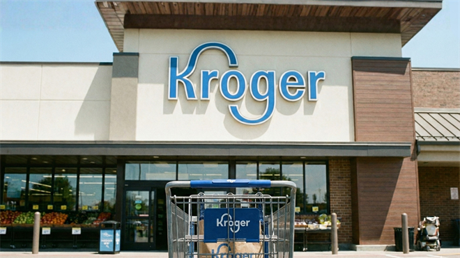 Kroger storefront, with a cart of groceries in the foreground. 