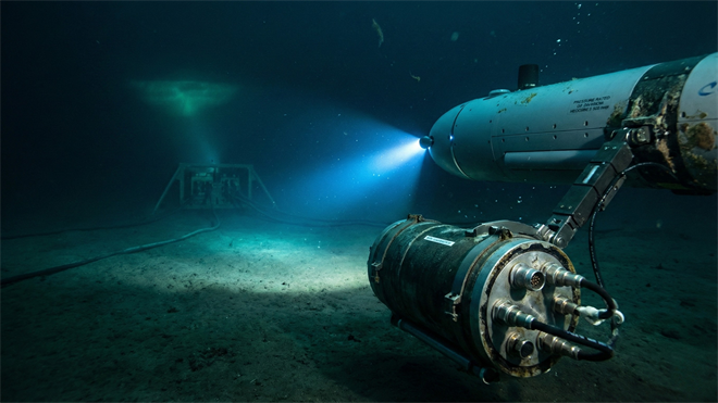 AUV installs a pressure-rated subsea battery module on the seafloor, reflecting Kraken Robotics’ deep-ocean tech.