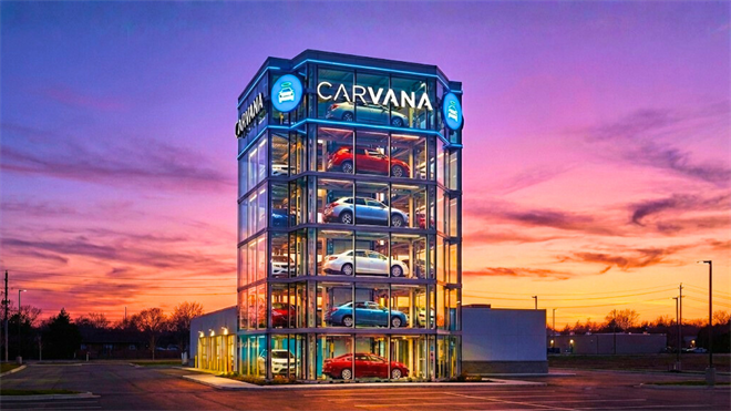 Carvana car vending machine tower at sunset, highlighting online used-car sales growth and CVNA stock.
