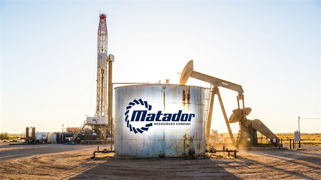 Matador Resources logo on oil tank beside a pumpjack and drilling rig.
