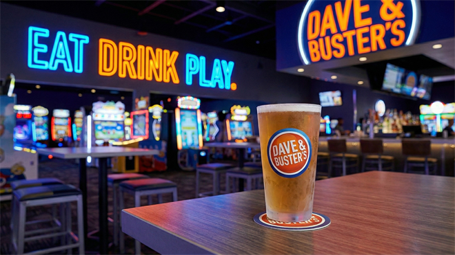 Interior of a Dave & Buster’s arcade restaurant with neon signage and drinks, highlighting arcade dining industry growth.