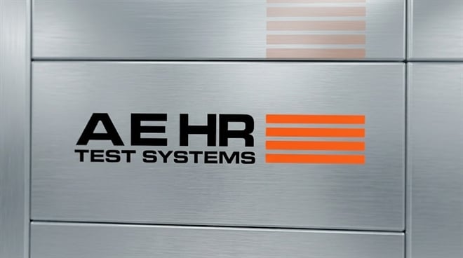Aehr Test Systems logo centered on a brushed metal panel background.