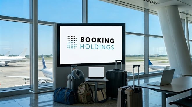 An airport screen displaying a Booking Holdings advertisement is surrounded by various suitcases and travel bags.