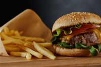 Fast food stocks Delicious burger with meat and french fries on wooden surface 