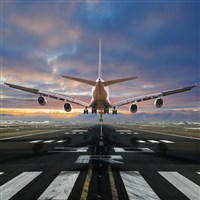 Airplane landing at the airport, back view. Learn about how to invest in the best airline ETFs.