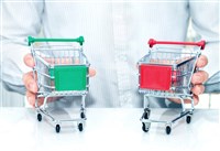 image of two shopping carts to illustrate consumer staples vs. consumer discretionary
