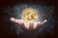 Man hands showing golden bitcoin; what are cryptocurrencies? Learn more.