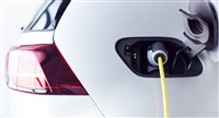 Close Up Of Power Cable Charging Environmentally Friendly Zero Emission Electric Car In Garage