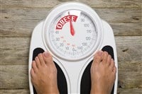 photo of feet on scale with scale reading obese