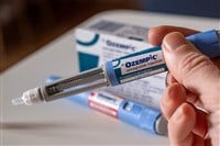 Photo showing a person holding an Ozempic vial. Novo Nordisk enhances Wegovy to be triple threat in Type 2 diabetes treatment and weight loss.