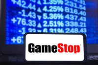  In this photo illustration a GameStop logo seen displayed on a smartphone with the stock market graphic in the background