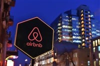 Airbnb sign in front of cityscape