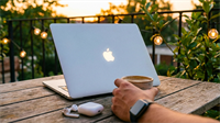 Apple MacBook and AirPods on patio table as investor checks AAPL, spotlighting consumer tech demand.