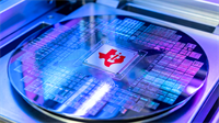 Texas Instruments logo on a silicon wafer, highlighting semiconductor manufacturing capacity and chip demand trends.