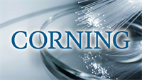 Corning logo over glowing fiber-optic strands, highlighting its AI data-center connectivity business.