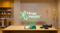 Hinge Health logo in a physical therapy clinic with tablet, highlighting digital health and musculoskeletal care.