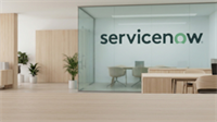 Modern ServiceNow office interior with glass conference room and logo on wall, reflecting enterprise software and AI-driven rebound theme.