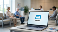 Laptop displaying Abbott logo in a clinic waiting room, highlighting healthcare company amid stock downturn context.
