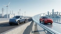 Ford electric pickup and SUV drive past wind turbines, highlighting legacy automakers' EV affordability push.
