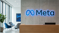 Meta office lobby with illuminated logo on concrete wall, representing big tech and social media industry.