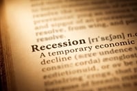 Close-up of a dictionary entry defining the word "Recession" as a temporary economic decline.