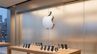 An Apple retail store display table showing iPhones and an Apple Watch beneath the Apple logo.