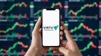 Hands holding a smartphone displaying the Virtu Financial logo with stock charts in the background.