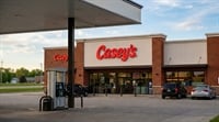 Exterior of a Casey's General Store convenience store and gas station with fuel pumps in the foreground.
